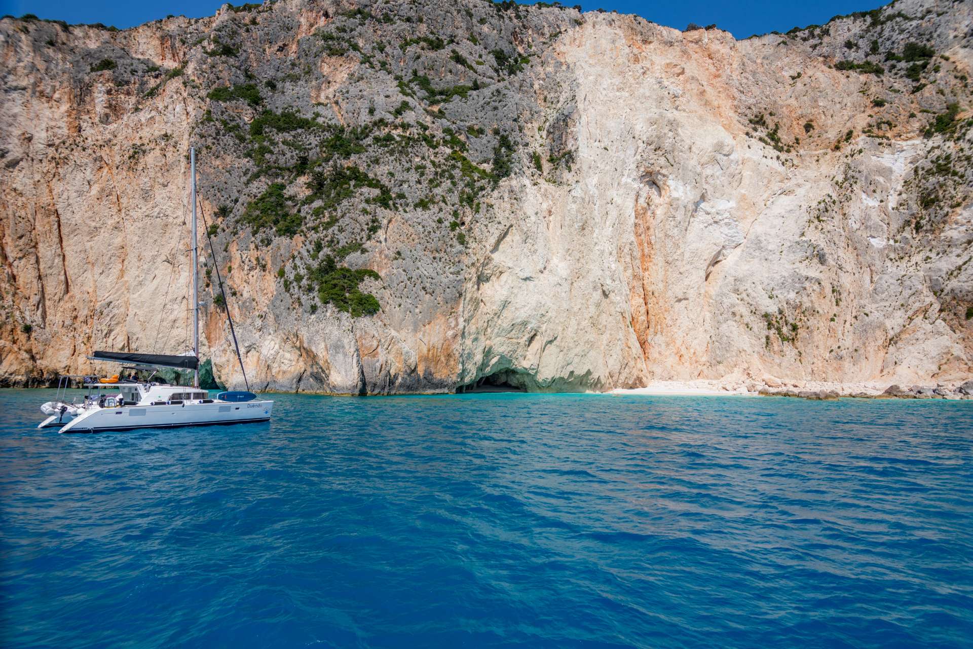 Catamaran boat gliding over the turquoise waters near Crete